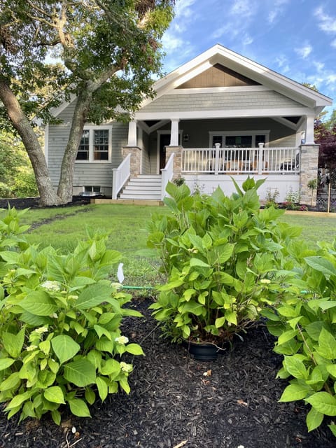Front of house, yard, covered porch, sitting area
