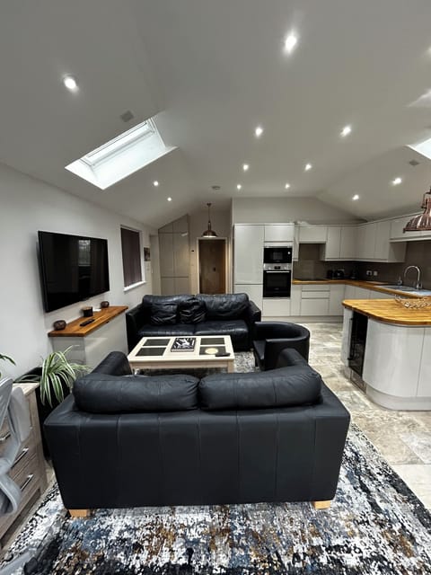 Lounge, living area, 2 comfortable sofas, coffee table and tv screen