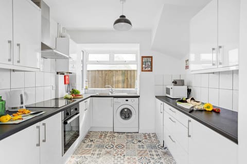 The kitchen with a washing machine - Lighthouse View