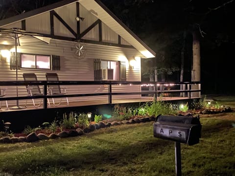 Wrap around porch with night lights, rocking chairs, umbrella table and 4 chairs