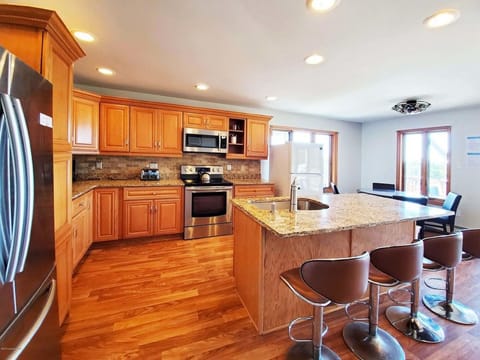 4 bar stools. Sliders walks out to BBQ grill, fire pit table, dining sets