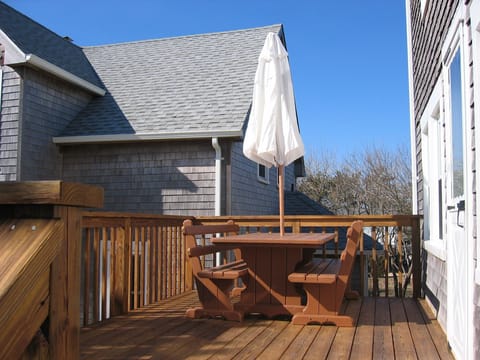 Great deck with awesome picnic table with back rests and umbrella