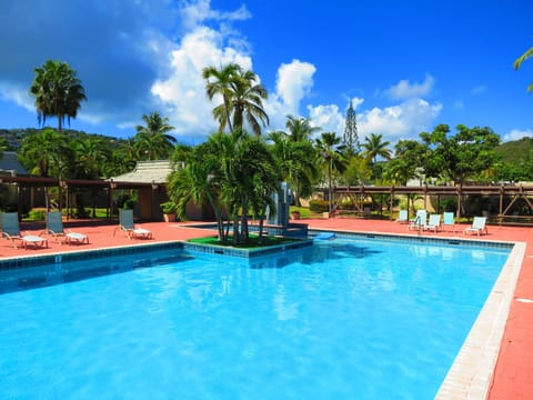 Pineapple Village Pool with complimentary sunlounges and covered areas.