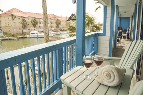 Sip your evening wine on your private balcony while watching boats drift by the marina below.