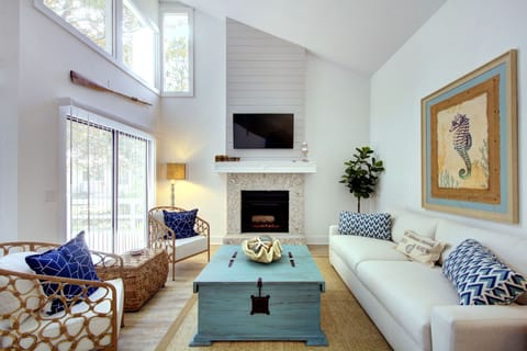 Vaulted Living Room Near Myrtle Street Beach - Bright seating, tall windows, and a smart TV give this St. Simons rental a strong main gathering space after the 0.2-mile walk from Myrtle Street Beach.