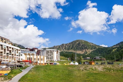 Green slopes in summer, the same terrain that fills with snow each winter just outside the residence.