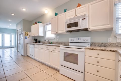 Kitchen - The spacious kitchen offers both small and large appliances. A built in microwave, dishwasher, oven with smooth cooktop and a refrigerator-freezer with ice maker is all included along with a coffee maker, blender, and toaster to name a few. The cabinetry is fully stocked with all of the items you will need for preparing your meals on site. Just bring the groceries!