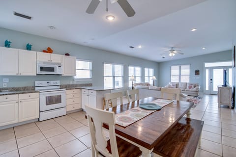 Kitchen/Dining - The dining area offers a table with seating for 6-8 depending on how many you want to fit on that bench! The spacious design of this room offers quality time with every member of your group, whether they are watching a program on TV in the living area or meal prepping in the kitchen.