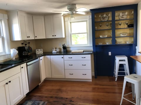 Kitchen fully stocked with appliances, dishware, etc