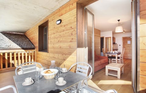 Some rooms have a balcony with a table