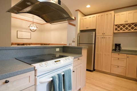 Convection oven with electric range and coffee pot.