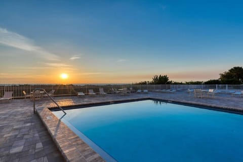 Sunset reflections shimmer across the pool, creating a peaceful spot to unwind as the day fades.