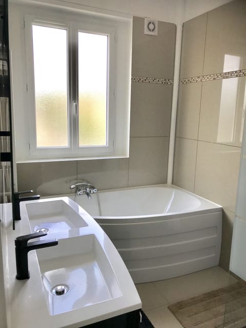 A smart bathroom with italian shower, bath tub, double sink