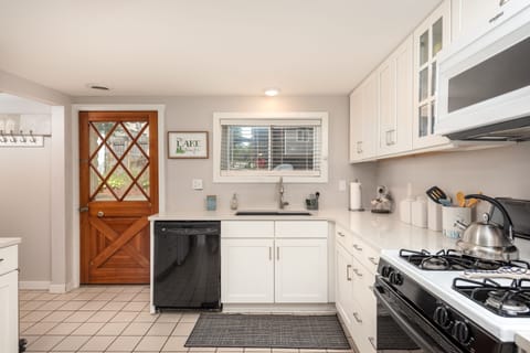 Kitchen with access to back patio and open floor plan to family room