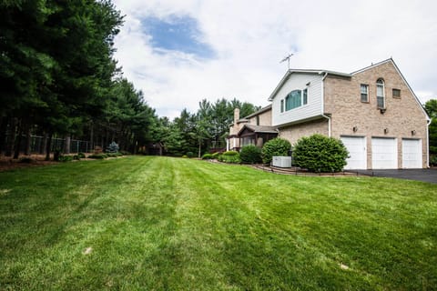 Spacious backyard with 3 car garage and home generator