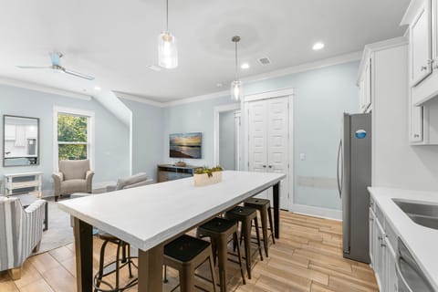 Enjoy the open-concept living and dining area with a stocked kitchen