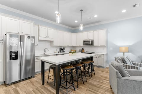 Enjoy the open-concept living and dining area with a stocked kitchen