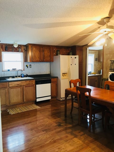 Eat-in kitchen has antique oak table and chairs