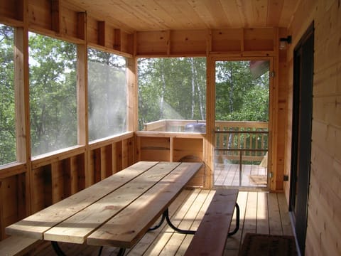 Screened porch is great for dining.
