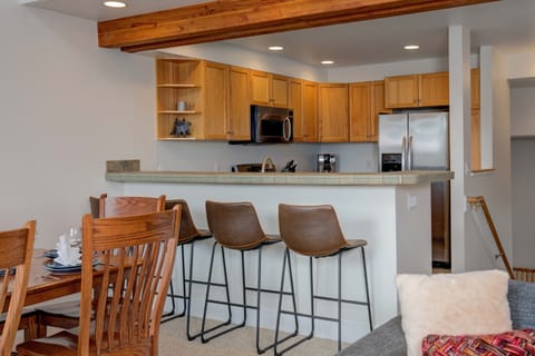 Three additional seats for meals at the bar unites kitchen and dining table