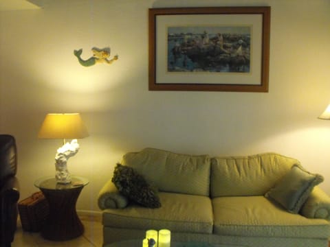 Airy living room with pull-out sofa and leather recliner to the left