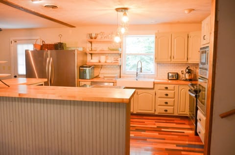 Kitchen has 2 refrigerators and 2 ovens