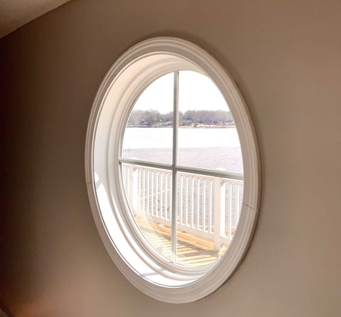 Port hole view to see the lake and the dock.