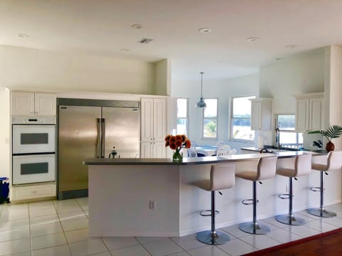 Kitchen area with oversized / modern refrigerator.  
