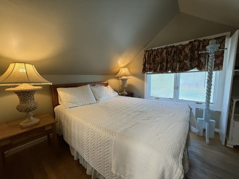 Queen Bed in bedroom with nice windows for light.
