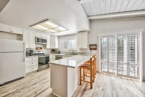 Sip wine at the marble counter while dinner is cooking