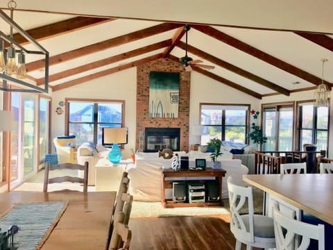 large open living, dining room and kitchen -- with wood burning fireplace