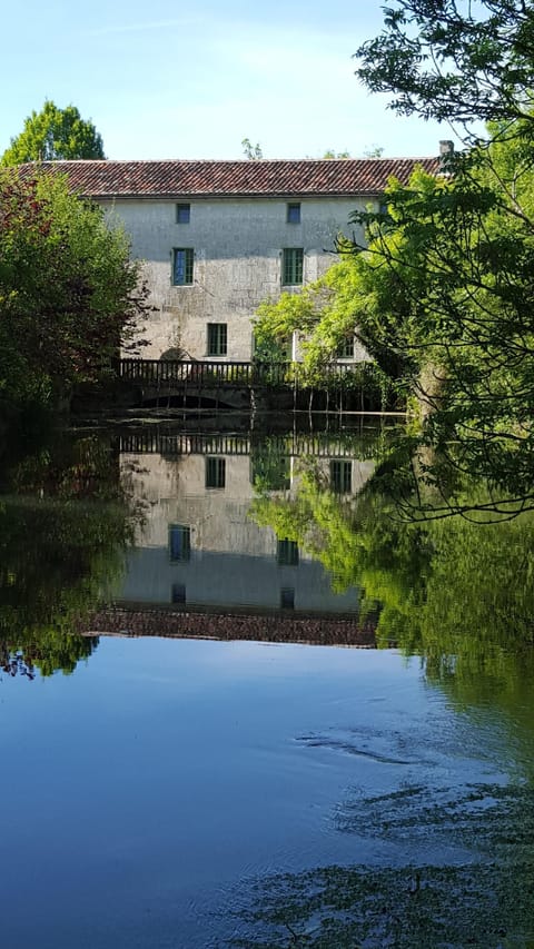 South side of watermill with new green windows,overlooking the river Seugne