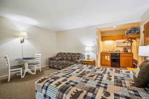 Relax in the living area with a pull out sofa, dinette, TV, and sliding glass doors leading to the padio.