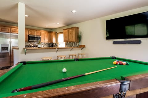 View from pool table, over bar, into kitchen