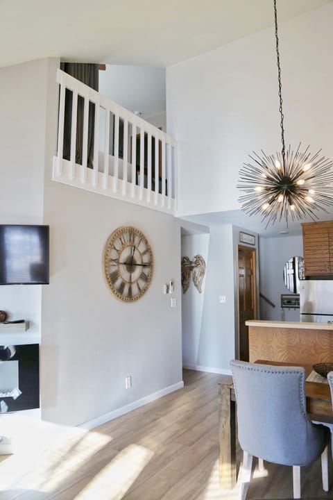 View on the staircase and lofted upstairs bedroom with king size bed.