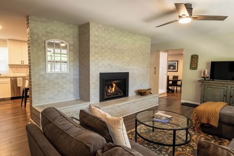 family room with view to kitchen left. Dining room and bath with step down right