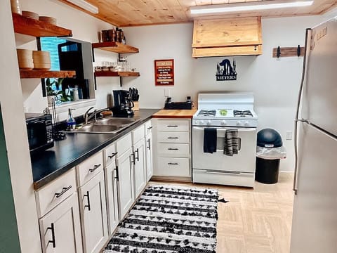 The kitchen includes appliances, cookware, and basic amenities.