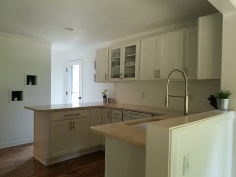 Kitchen with dishes, pans, toaster, french press, etc 
