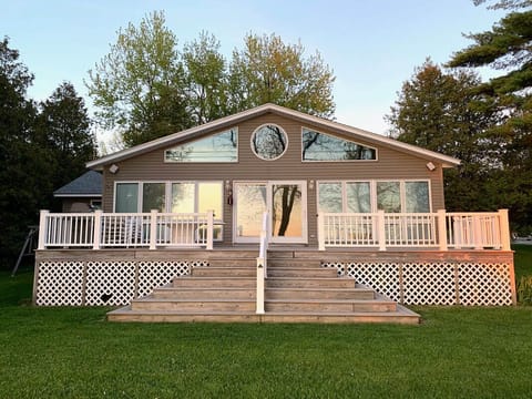 Front of the home. Deck accessible from door, stairs, and ramp. 