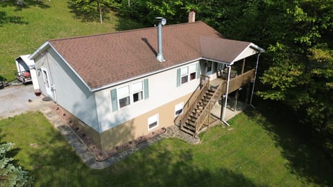 The Main Entrance is the side door with 1 step next to the driveway