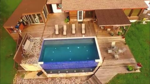 Enclosed cabana with heat and air next to the outdoor kitchen