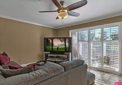 Living room with large sectional and large HD TV.