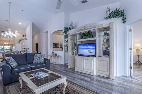 Blue loveseat with matching sofa has replaced the old.  Flatscreen TV with Cable.