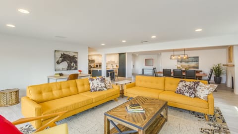 - Open living area with yellow sofas and wood accents   - Seamless flow into dining and kitchen gathering   - Central hub for relaxing, entertaining, and fun
