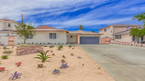 - Front exterior with desert landscaping and driveway   - Spacious entryway with garage and modern curb appeal   - Perfect arrival view for guests to start their stay