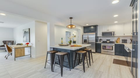 - Modern kitchen with island seating and stainless steel   - Bright open design perfect for cooking and gathering   - Fully equipped space ideal for meals and conversations