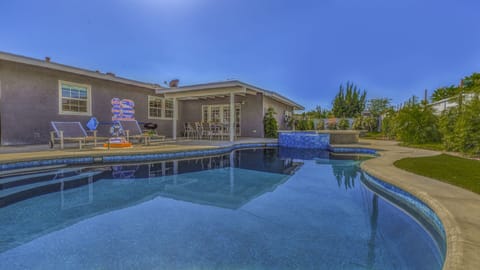 - Backyard pool with sparkling water and shaded patio seating area   - Perfect for family swimming and relaxing afternoons in the sun   - Private outdoor retreat designed for comfort and fun gatherings