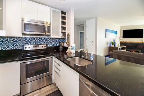 The blue backsplash in the kitchen complements the beach theme this condo has