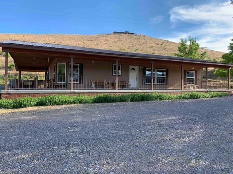 The front of the home has a wraparound porch with plenty of seating. 