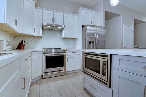 Prepare your meals in the well-equipped kitchen with top-notch stainless appliances.